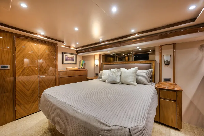 Benedetta Yacht Photos Pics Luxurious bedroom interior of 2012 Viking 70 Enclosed Bridge yacht with elegant wood finishes.