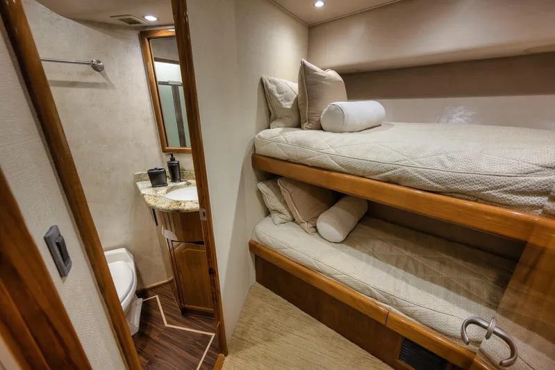 Benedetta Yacht Photos Pics Interior of 2012 Viking 70 Enclosed Bridge yacht with bunk beds and bathroom.