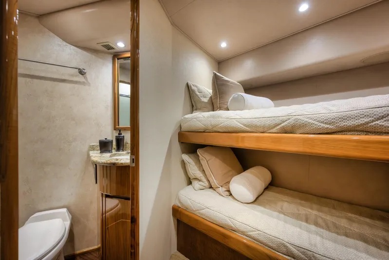 Benedetta Yacht Photos Pics Interior of 2012 Viking 70 Enclosed Bridge yacht with bunk beds and bathroom.