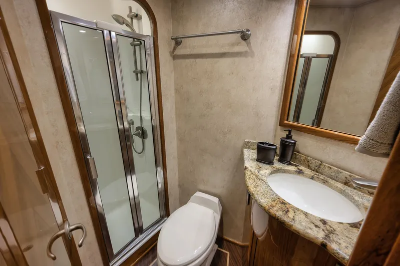 Benedetta Yacht Photos Pics Luxurious bathroom in 2012 Viking 70 Enclosed Bridge yacht with shower and granite countertop.