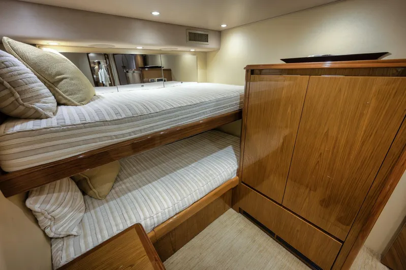 Benedetta Yacht Photos Pics Luxurious cabin interior of 2012 Viking 70 Enclosed Bridge yacht with bunk beds.