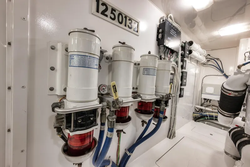 Benedetta Yacht Photos Pics Engine room of 2012 Viking 70 Enclosed Bridge yacht, featuring fuel filters and wiring.