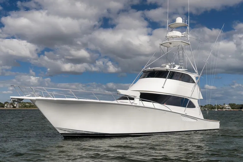 Benedetta Yacht Photos Pics 2012 Viking 70 Enclosed Bridge yacht on water under cloudy sky.