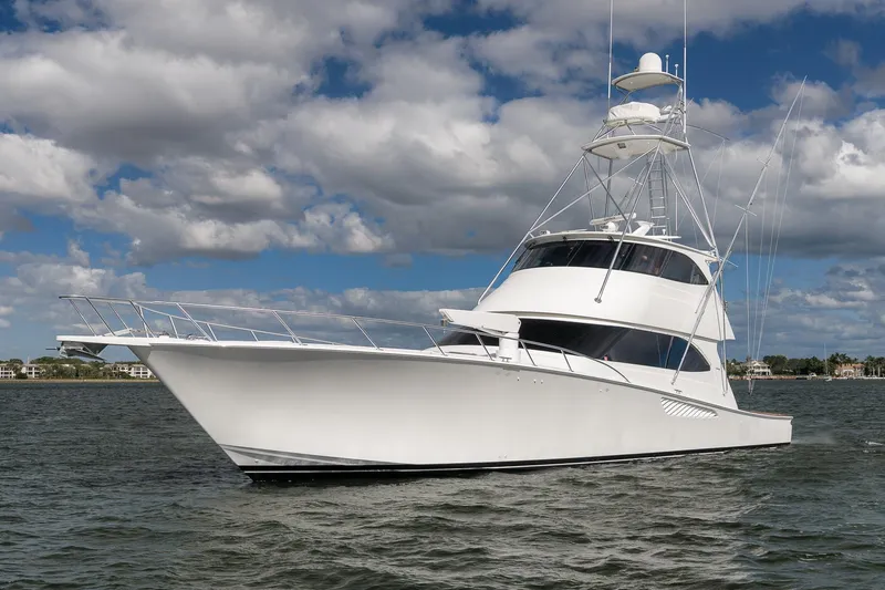 Benedetta Yacht Photos Pics Luxury 2012 Viking 70 Enclosed Bridge yacht on open water under cloudy sky.