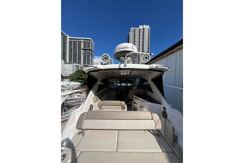 Yacht Photos Pics 2015 Regal 35 Sport Coupe yacht docked with city skyline background.