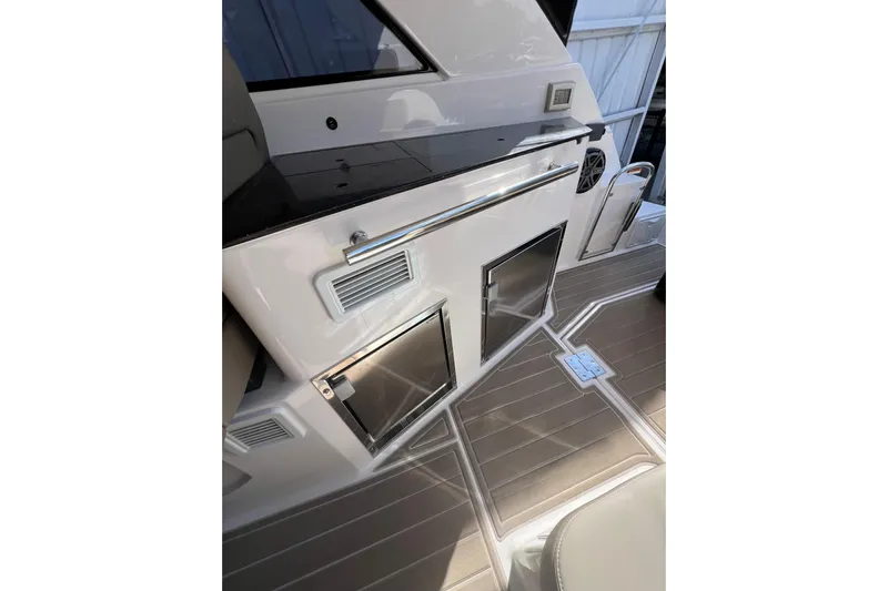  Yacht Photos Pics 2015 Regal 35 Sport Coupe interior with sleek cabinetry and modern flooring.