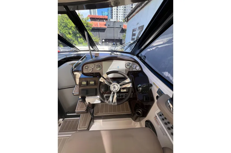  Yacht Photos Pics Cockpit of 2015 Regal 35 Sport Coupe with steering wheel and control panel.