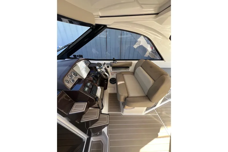  Yacht Photos Pics Interior of 2015 Regal 35 Sport Coupe, featuring helm and beige seating.
