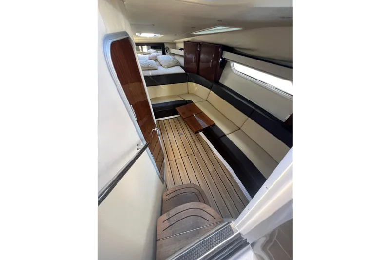  Yacht Photos Pics Interior of 2015 Regal 35 Sport Coupe with wood flooring and seating area.