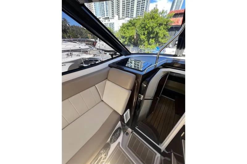  Yacht Photos Pics Interior of 2015 Regal 35 Sport Coupe yacht with beige seating and cityscape view.