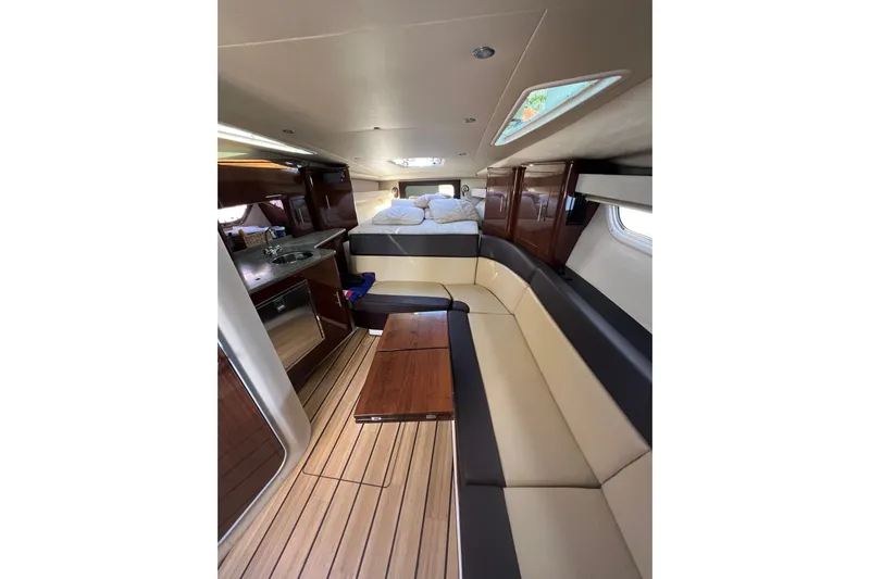  Yacht Photos Pics Luxurious interior of 2015 Regal 35 Sport Coupe with seating and kitchenette.