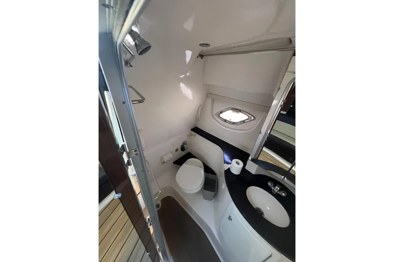  Yacht Photos Pics Bathroom interior of 2015 Regal 35 Sport Coupe yacht, featuring toilet and sink.