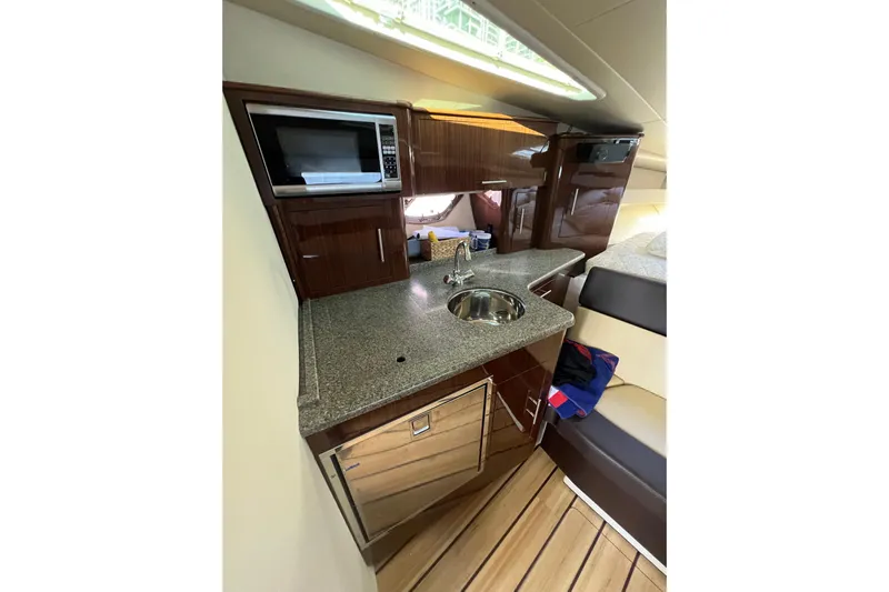  Yacht Photos Pics Luxurious 2015 Regal 35 Sport Coupe yacht interior with kitchenette and modern amenities.