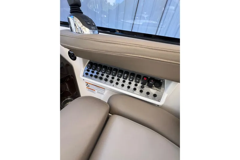  Yacht Photos Pics Control panel of a 2015 Regal 35 Sport Coupe boat with switches and buttons.