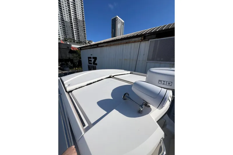  Yacht Photos Pics 2015 Regal 35 Sport Coupe boat rooftop with radar, urban skyline background.