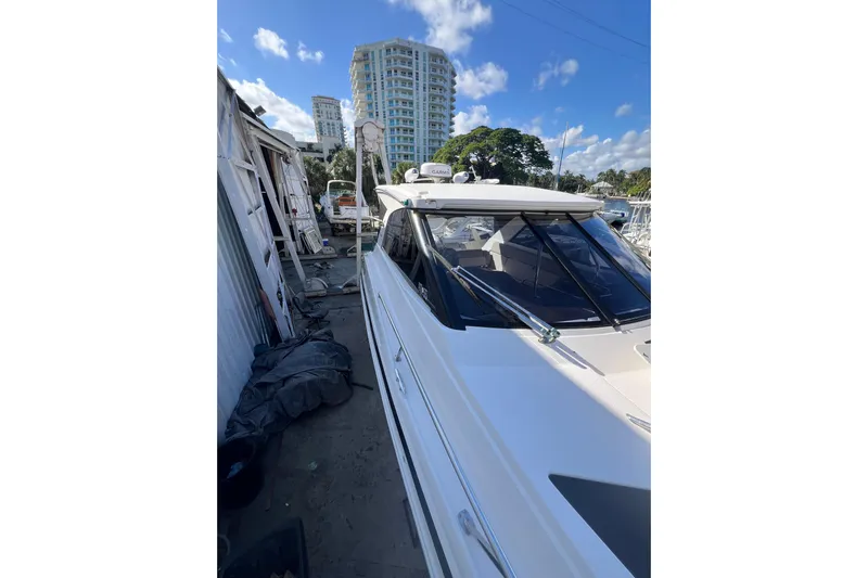  Yacht Photos Pics 2015 Regal 35 Sport Coupe yacht docked near urban buildings.