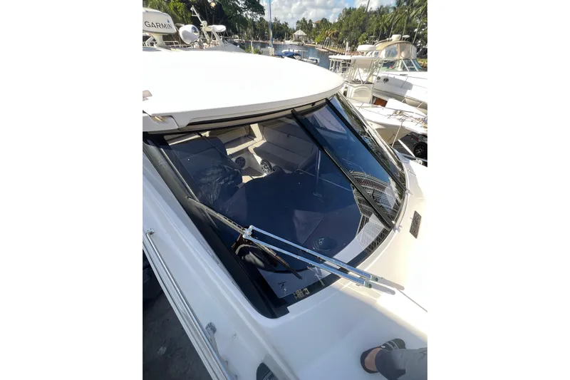  Yacht Photos Pics 2015 Regal 35 Sport Coupe boat with sleek windshield and marina background.