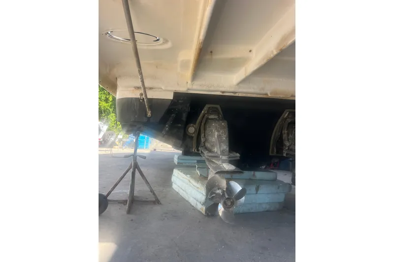  Yacht Photos Pics 2015 Regal 35 Sport Coupe boat underside with propeller and support stands.