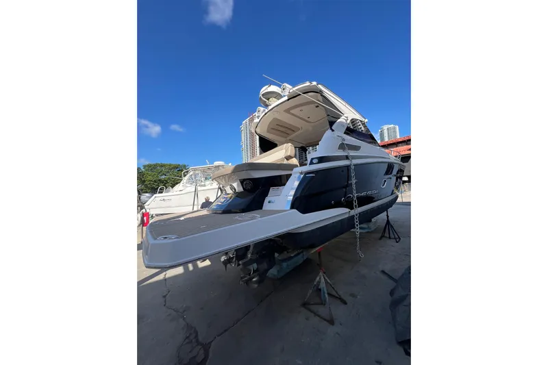 Yacht Photos Pics 2015 Regal 35 Sport Coupe yacht on dry dock under clear blue sky.