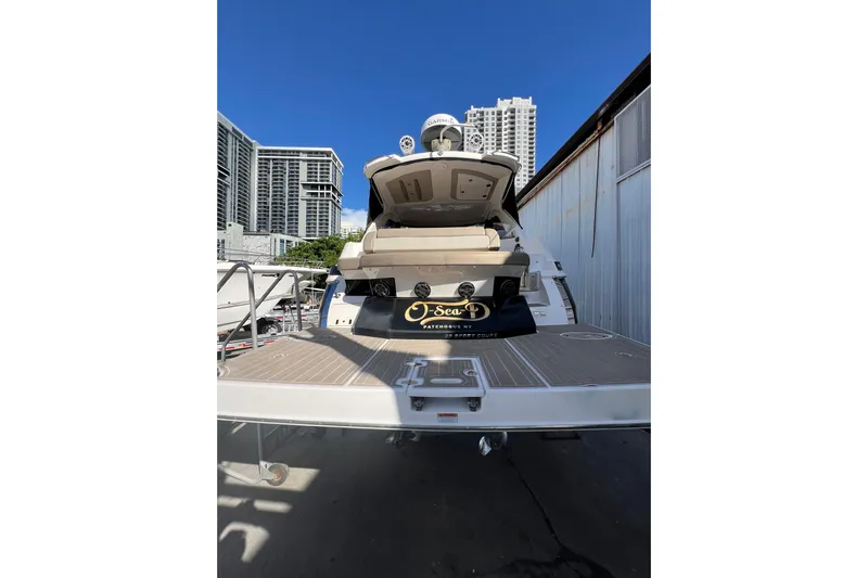  Yacht Photos Pics 2015 Regal 35 Sport Coupe yacht docked with city skyline background.