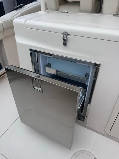  Yacht Photos Pics Grady-White Canyon 326 2022 boat with an open stainless steel refrigerator.
