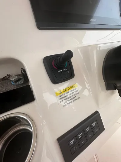  Yacht Photos Pics Control panel of a 2022 Grady-White Canyon 326 boat with joystick and display.