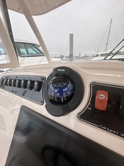  Yacht Photos Pics 2022 Grady-White Canyon 326 dashboard with compass and control panel.