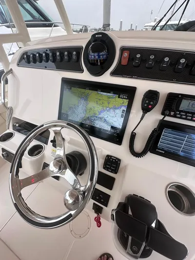  Yacht Photos Pics 2022 Grady-White Canyon 326 boat dashboard with navigation system and controls.