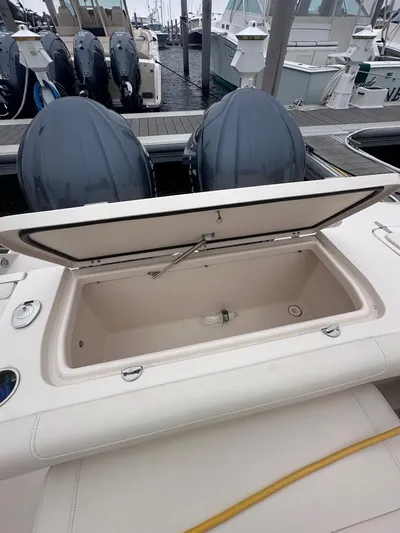  Yacht Photos Pics 2022 Grady-White Canyon 326 boat with open storage compartment and twin outboard engines.