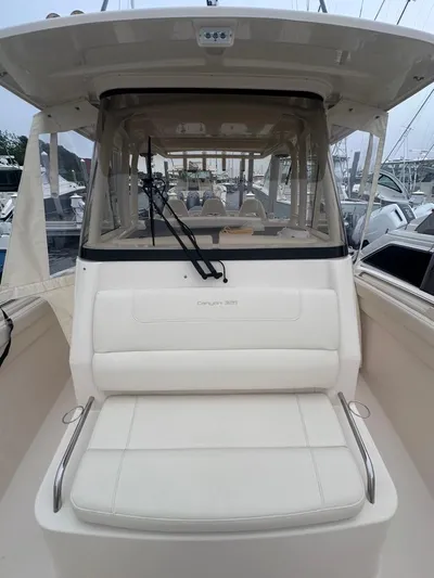  Yacht Photos Pics 2022 Grady-White Canyon 326 boat with cushioned seating and windshield.