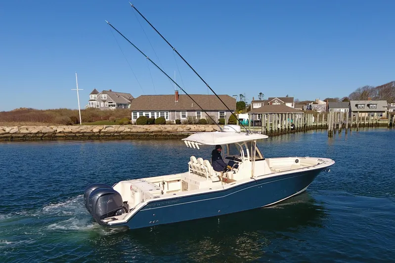  Yacht Photos Pics 2022 Grady-White Canyon 326 boat cruising near coastal homes and docks.