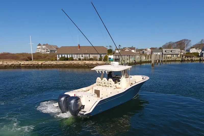  Yacht Photos Pics 2022 Grady-White Canyon 326 boat cruising near coastal homes.