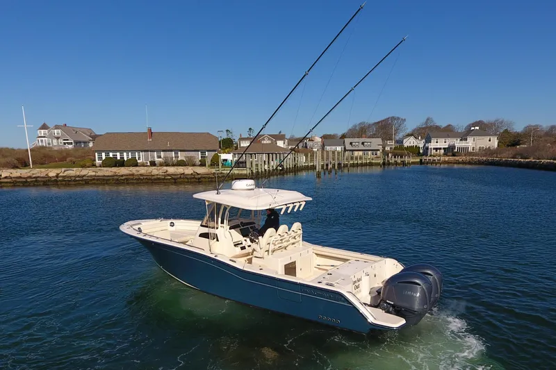  Yacht Photos Pics 2022 Grady-White Canyon 326 boat cruising in a scenic coastal area.