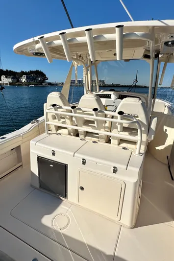  Yacht Photos Pics 2022 Grady-White Canyon 326 boat interior with seating and storage, docked by the water.
