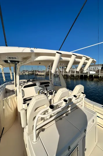  Yacht Photos Pics 2022 Grady-White Canyon 326 boat interior with rod holders, docked by the water.