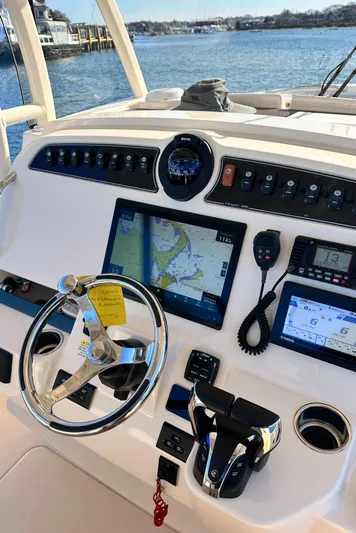  Yacht Photos Pics 2022 Grady-White Canyon 326 helm with navigation screens and controls, overlooking serene water.