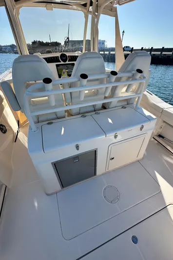  Yacht Photos Pics 2022 Grady-White Canyon 326 boat interior with seating and storage, docked by the water.
