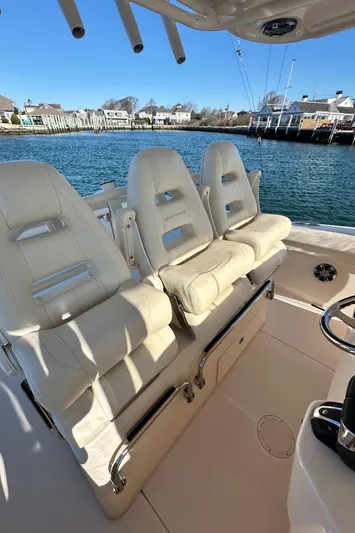  Yacht Photos Pics 2022 Grady-White Canyon 326 boat with luxurious seating, docked by the waterfront.