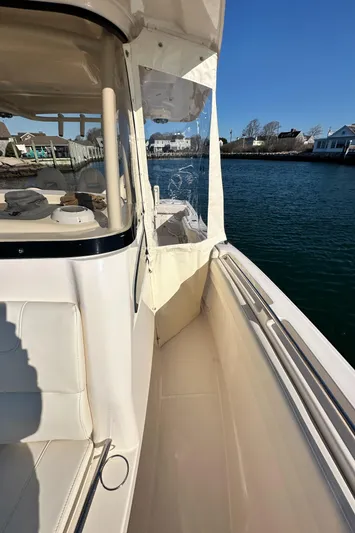  Yacht Photos Pics 2022 Grady-White Canyon 326 boat, side view, docked near waterfront homes.