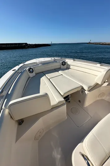  Yacht Photos Pics 2022 Grady-White Canyon 326 boat with spacious seating, docked by the ocean.