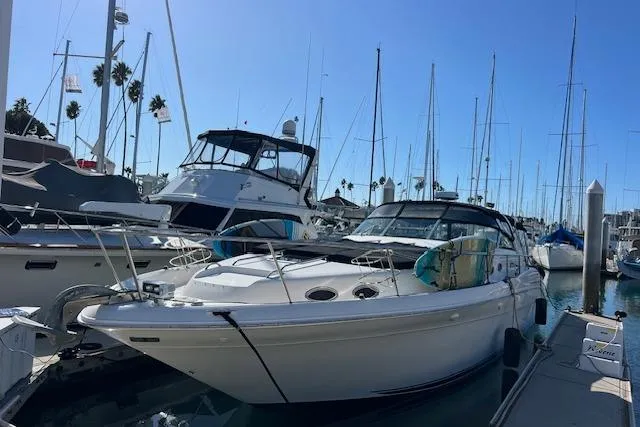 Knot For Sail Yacht Photos Pics 1997 Sea Ray 450 Sundancer docked at marina with other boats.