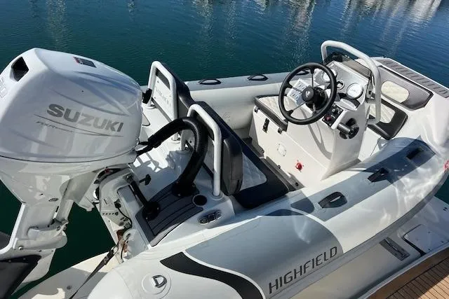 Knot For Sail Yacht Photos Pics Highfield boat with Suzuki outboard motor, docked on calm water. Sea Ray 450 Sundancer, 1997.