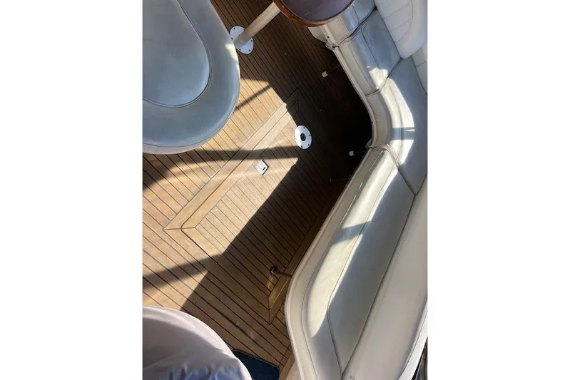 Knot For Sail Yacht Photos Pics 1997 Sea Ray 450 Sundancer interior with wooden flooring and cushioned seating.