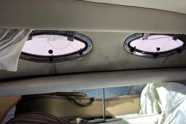 Knot For Sail Yacht Photos Pics Interior view of 1997 Sea Ray 450 Sundancer with oval windows and luggage.