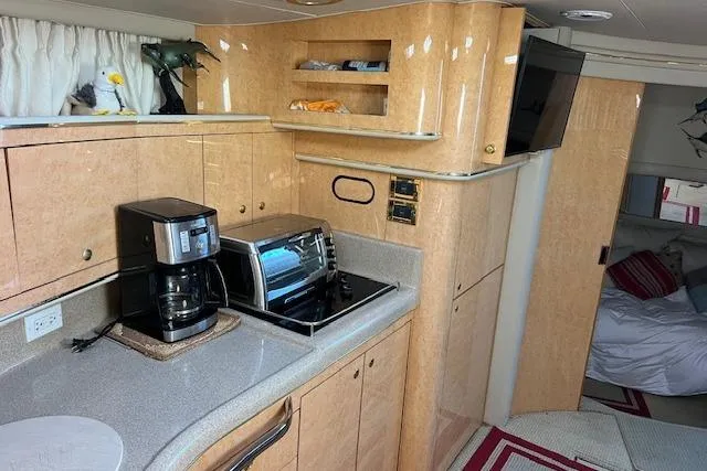 Knot For Sail Yacht Photos Pics Interior of 1997 Sea Ray 450 Sundancer yacht with kitchen appliances and cozy cabin.