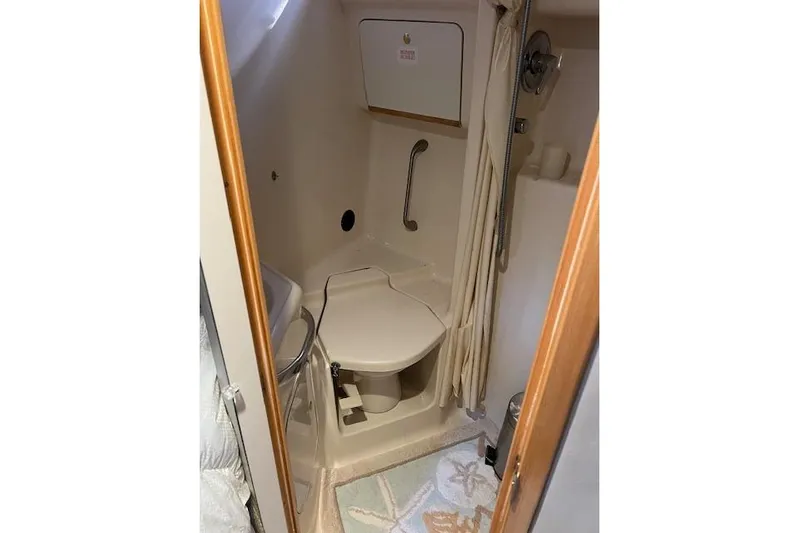 Knot For Sail Yacht Photos Pics Bathroom interior of 1997 Sea Ray 450 Sundancer yacht, featuring compact design and amenities.