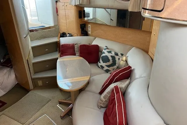 Knot For Sail Yacht Photos Pics Interior of 1997 Sea Ray 450 Sundancer with cozy seating and decorative pillows.