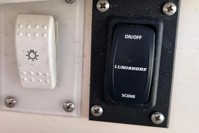 Knot For Sail Yacht Photos Pics Switch panel on a 1997 Sea Ray 450 Sundancer boat, featuring Lumishore lighting controls.