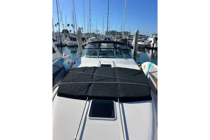 Knot For Sail Yacht Photos Pics 1997 Sea Ray 450 Sundancer yacht docked at marina, sunny day, sleek design.