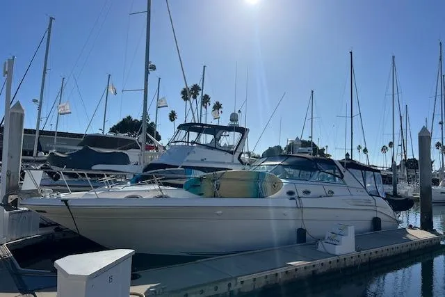 Knot For Sail Yacht Photos Pics 1997 Sea Ray 450 Sundancer yacht docked at marina under clear blue sky.
